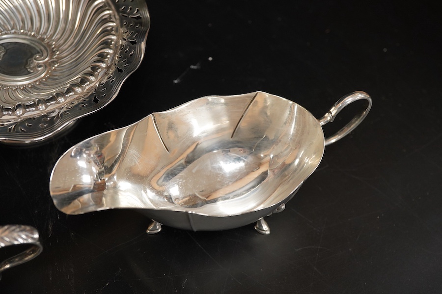 A late Victorian repousse silver bonbon dish, Kemp Bros. London, 1897, diameter 15.1cm, together with two silver sauceboats, 10oz.